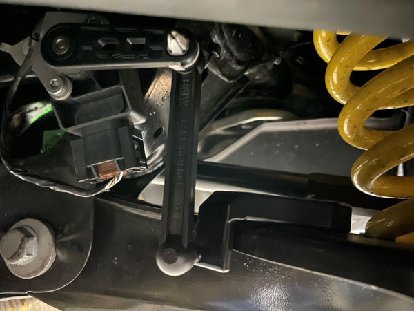 Billet rear ride height sensor bracket installed on Toyota Supra A90 rear suspension